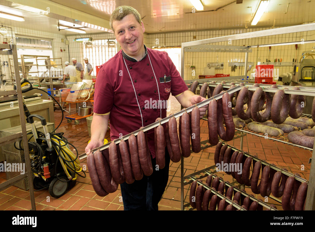 A butcher shows his sausages in his butchery Stock Photo Alamy