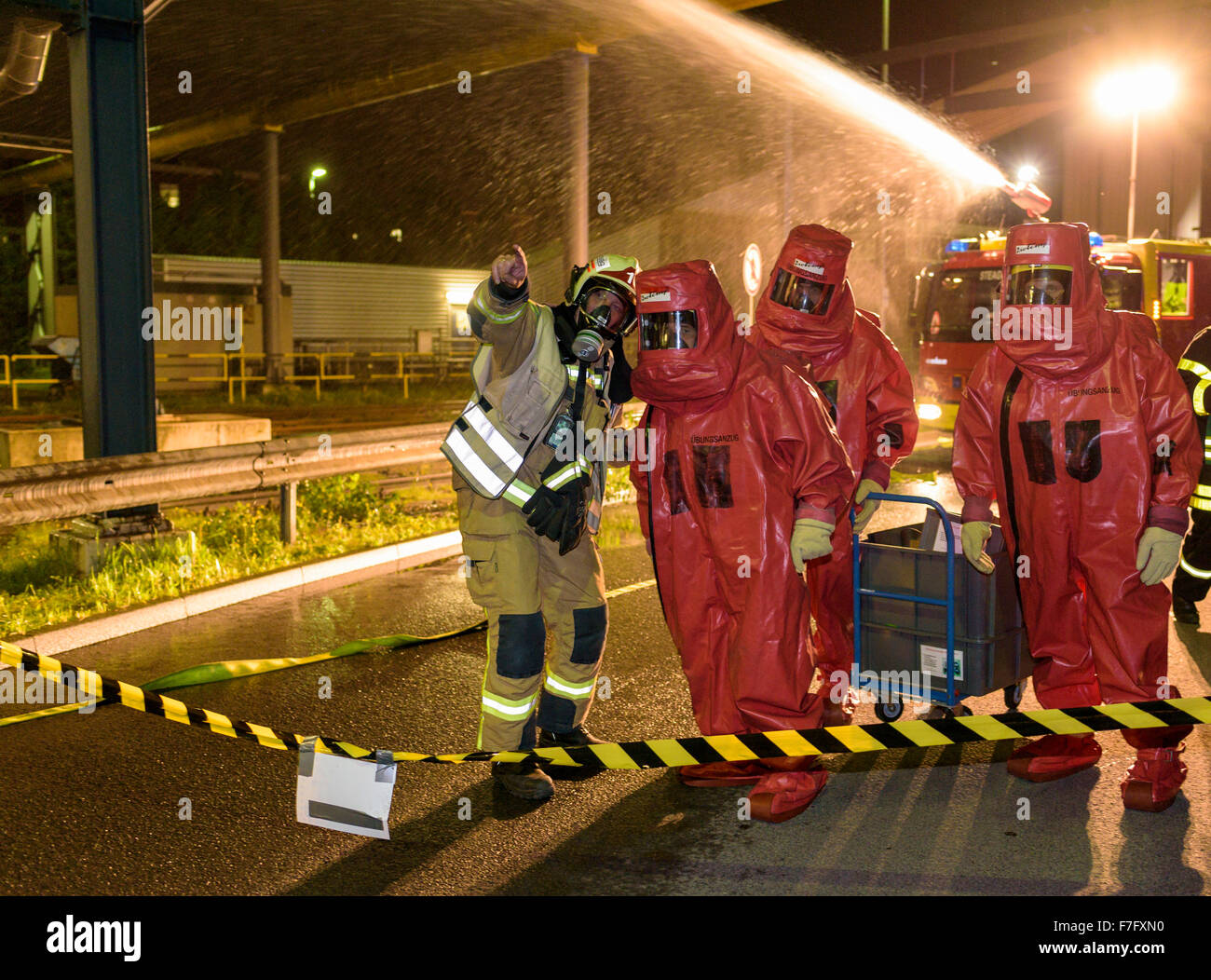 Firefighters in abc protective suits practice for an emergency in a power plant. Stock Photo