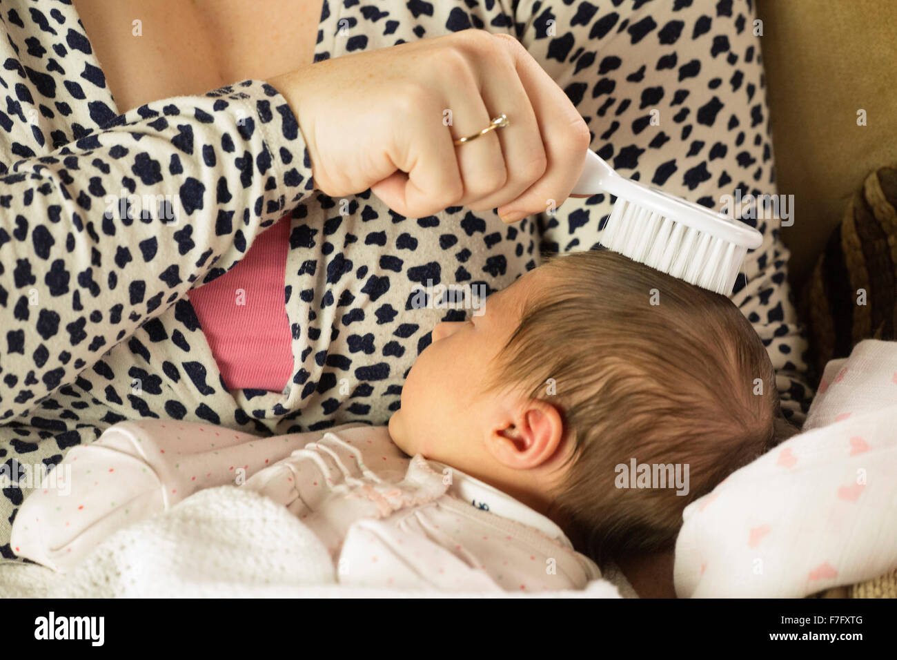 mum brushing newborn baby hair Stock Photo Alamy