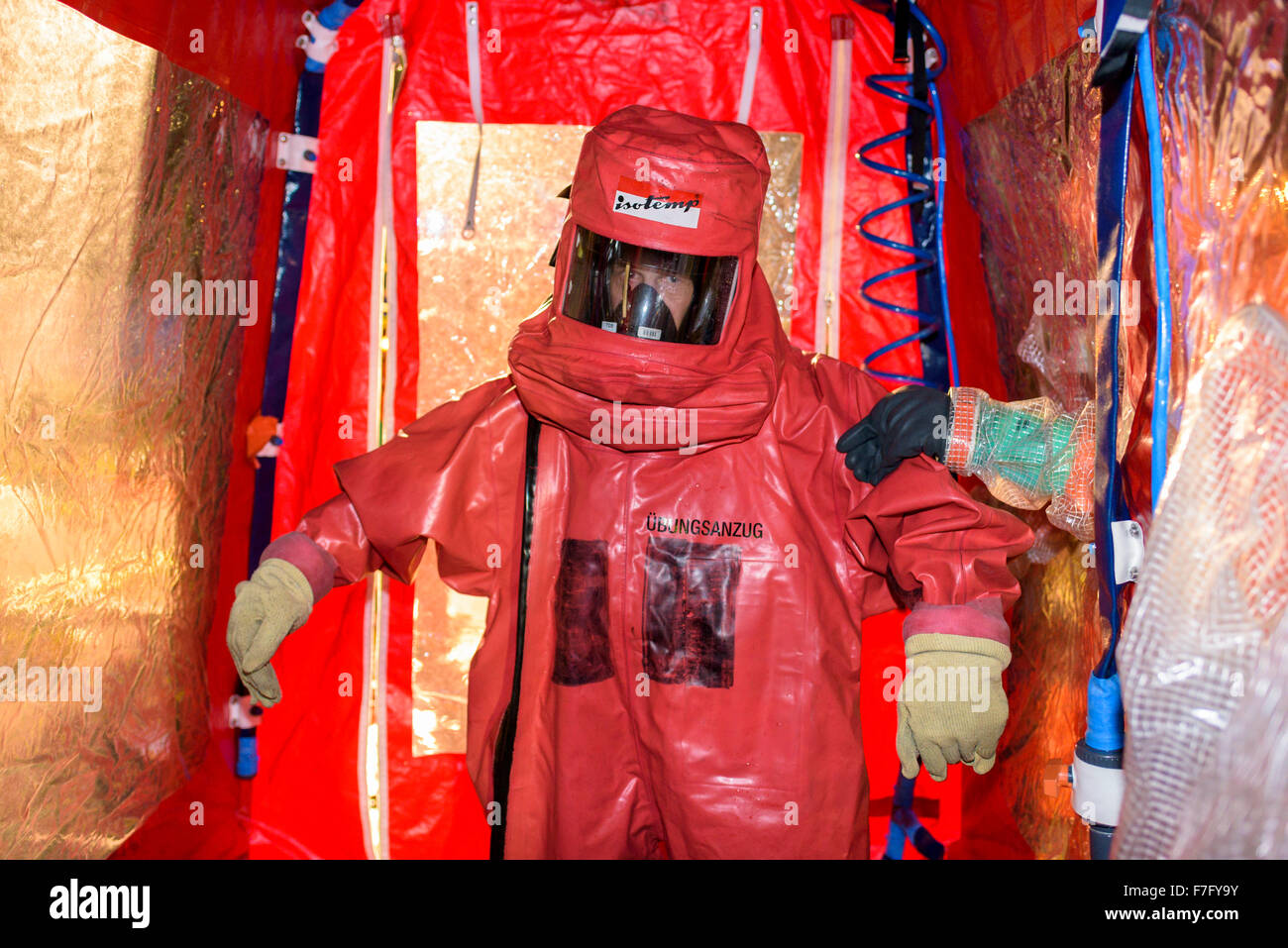 Firefighters in abc protective suits practice for an emergency in a power plant, using a decontamination facility. Stock Photo