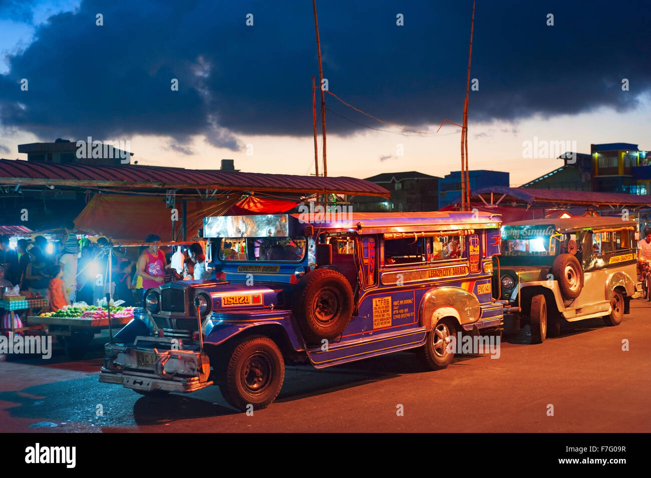 Jeepneys waiting for passengers on the street. Jeepneys are public transport. Stock Photo