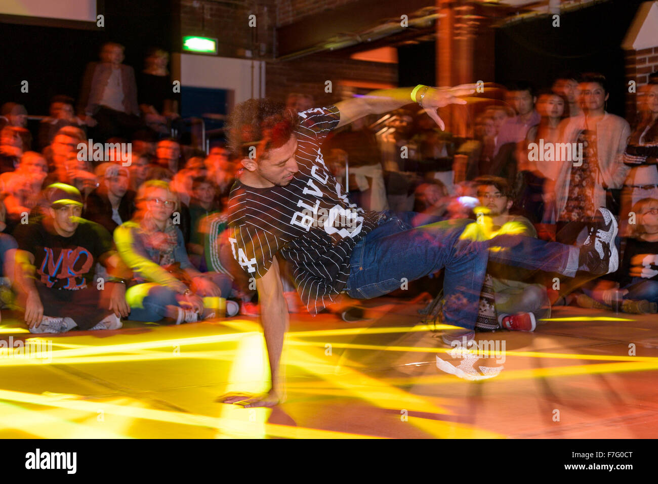 A young break dancer performs on a stage at a break dance competition. Stock Photo