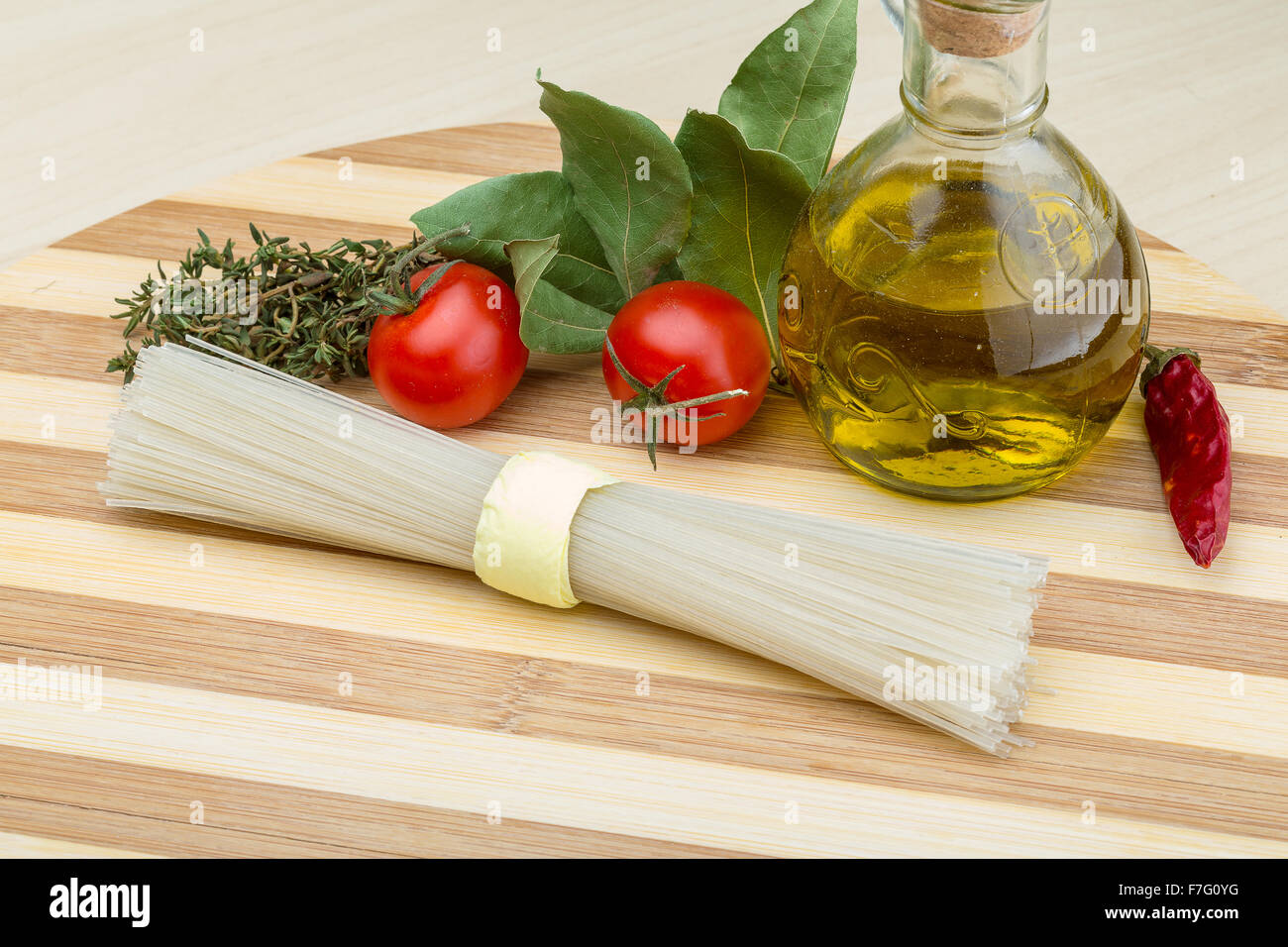 Spaghetti With Rice Model Raw rice spaghetti with herbs and olive oil Stock Photo - Alamy