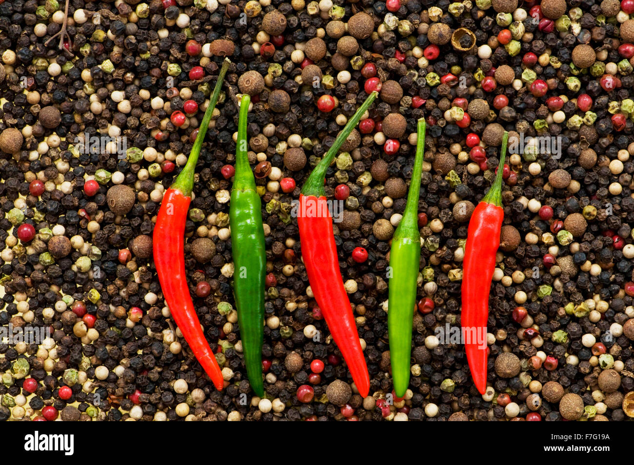 Red and green peppers on pepper background Stock Photo - Alamy