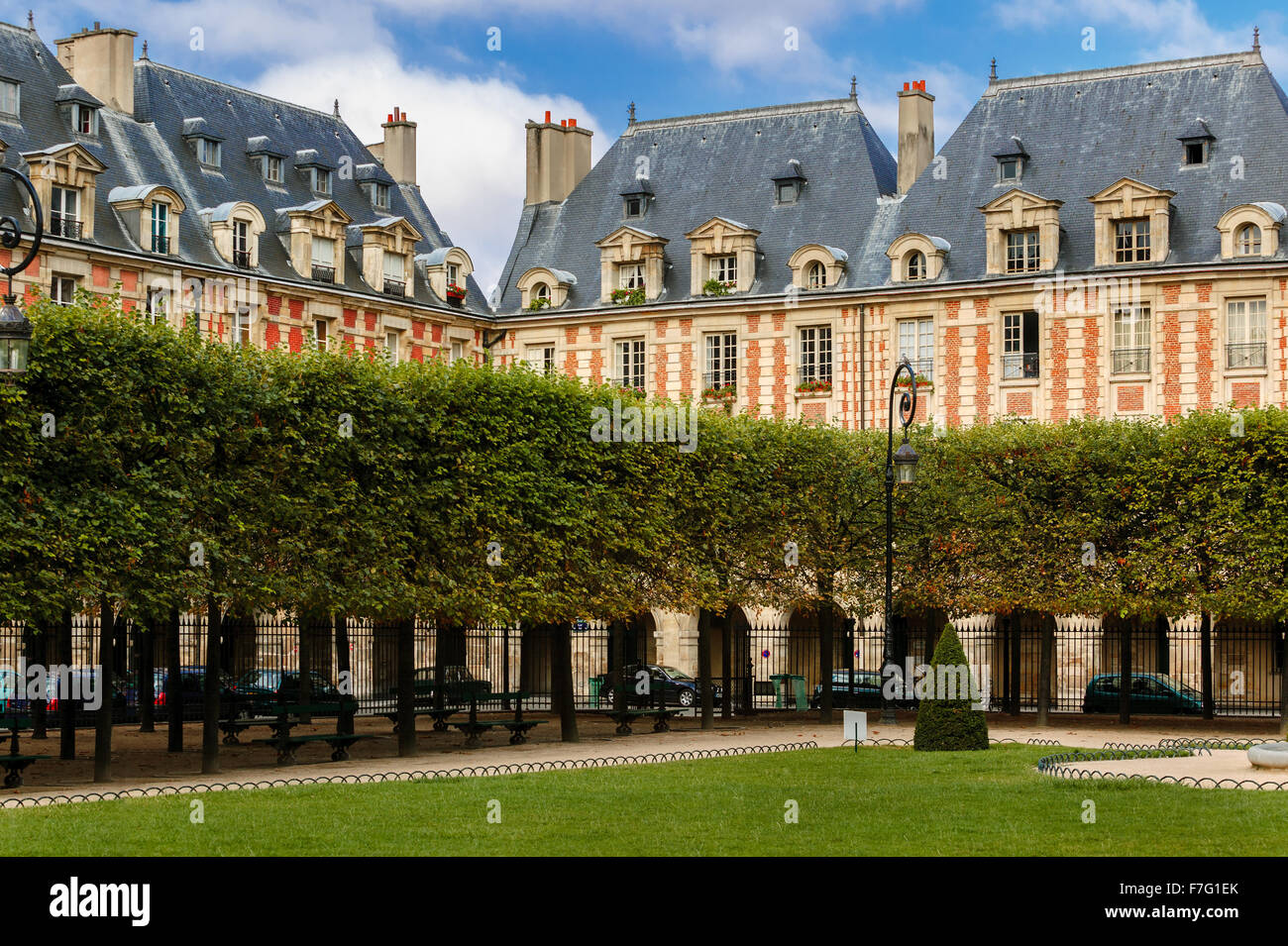 Garden and housefronts (with blue slates dormer roofs) on Place des Vosges in Le Marais, 4th arrondissment, Paris, France. Stock Photo