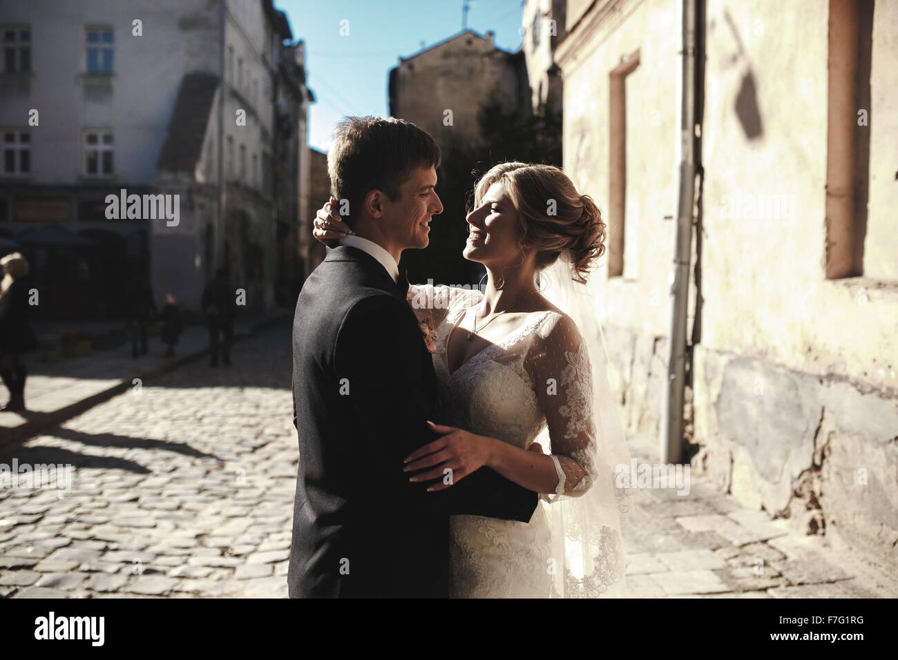 bride and groom posing on the streets Stock Photo - Alamy