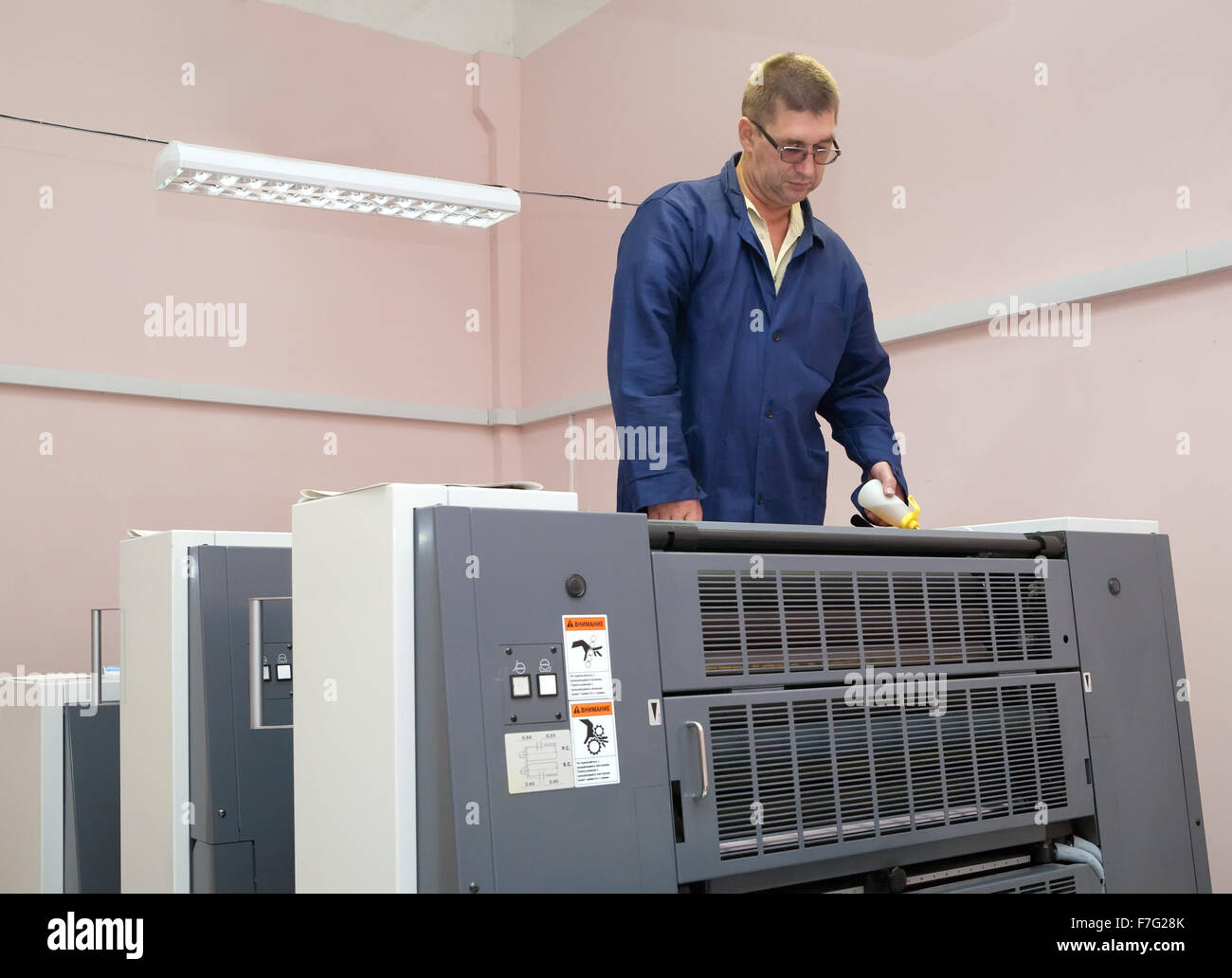 Offset Machine Working Printer working at his modern offset machine Stock Photo - Alamy
