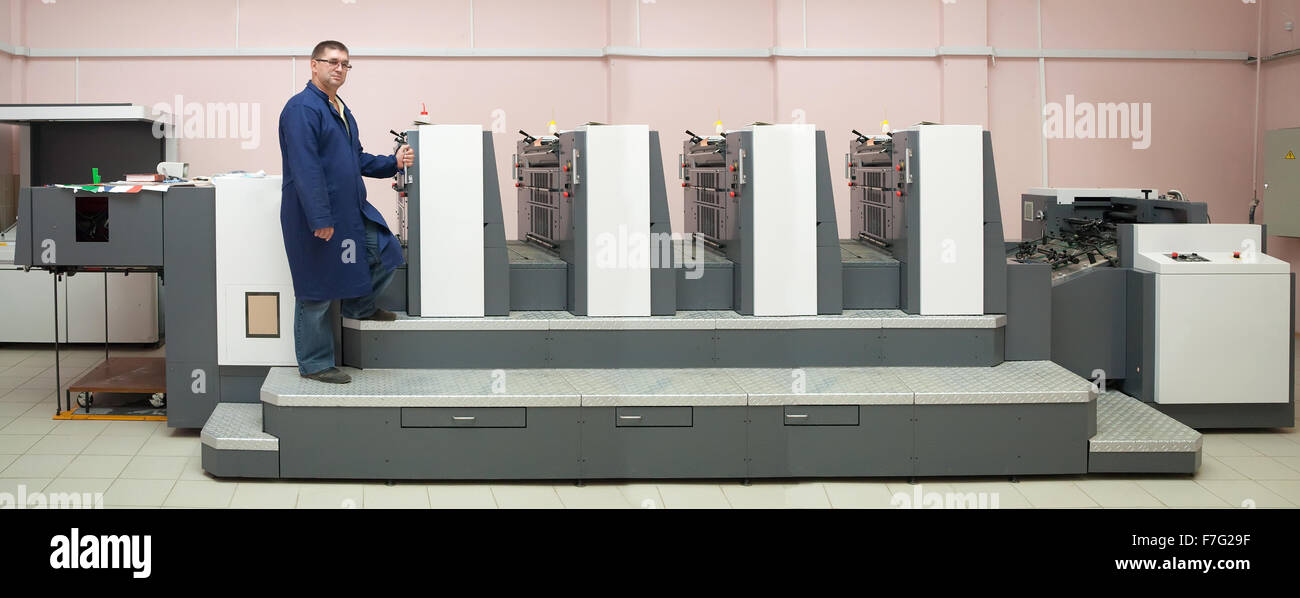 Offset Machine Working Printer working at his modern offset machine Stock Photo - Alamy
