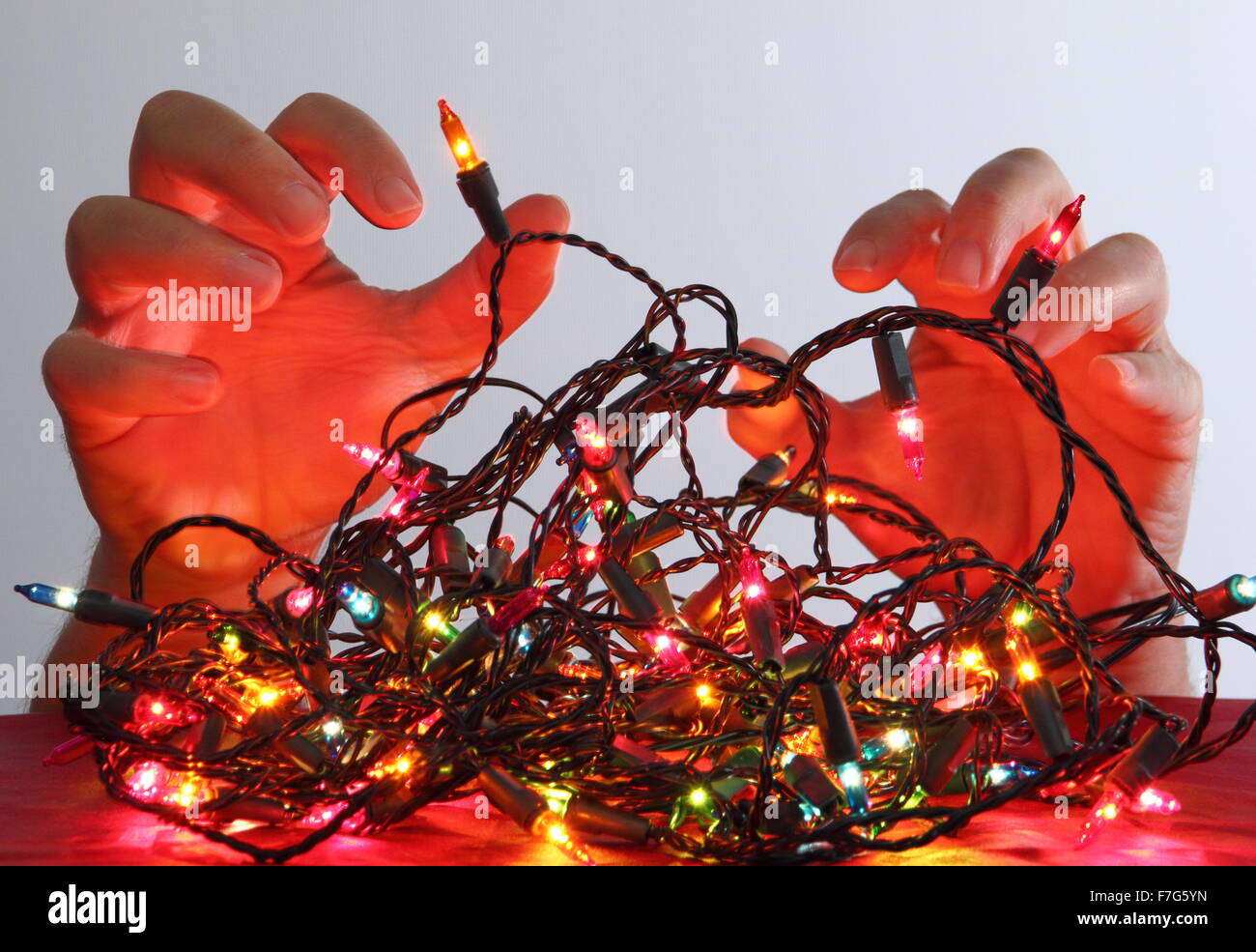 Man tangled in christmas lights hires stock photography and images Alamy