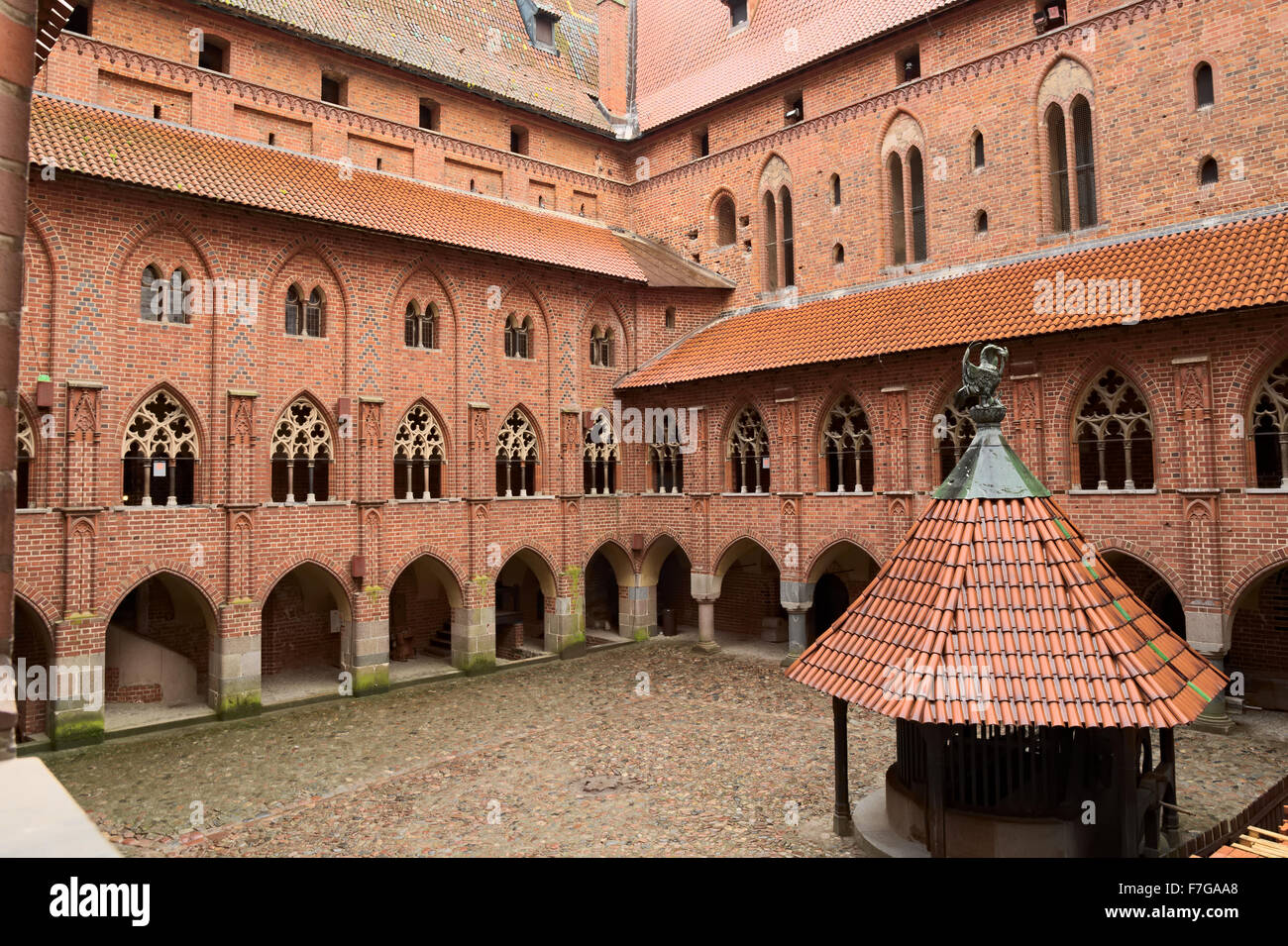 Yard with arcades and galleries in the medieval Castle of the Teutonic Order in Malbork (Marienburg), Poland. Stock Photo