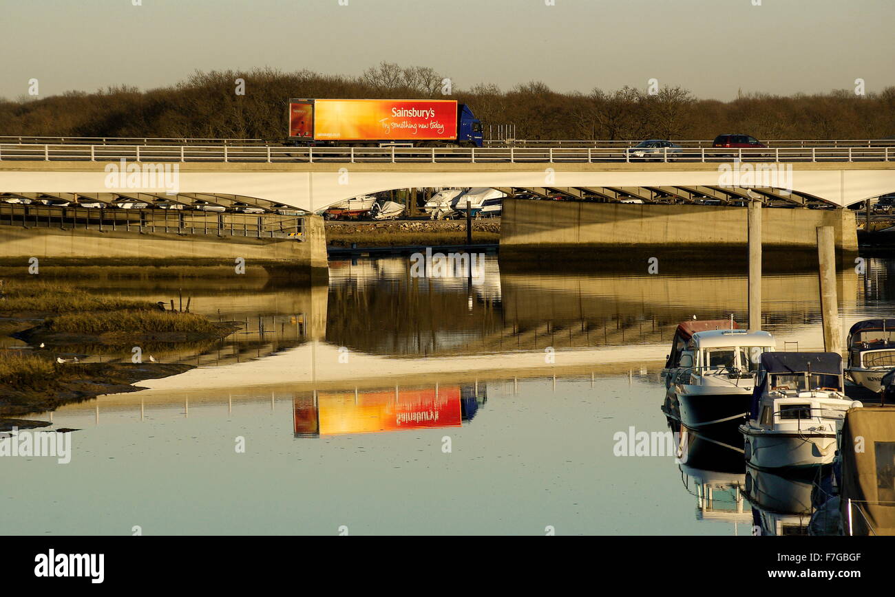 AJAXNETPHOTO. HAMBLE RIVER, ENGLAND. - M27 bridge motorway lorry traffic creates refelection in river. PHOTO:JONATHAN EASTLAND/AJAX REF:7112 140 Stock Photo