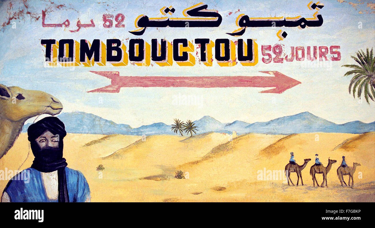 A painted sign of the desert pointing to Timbuktu from Zagora in Morocco, North Africa Stock Photo