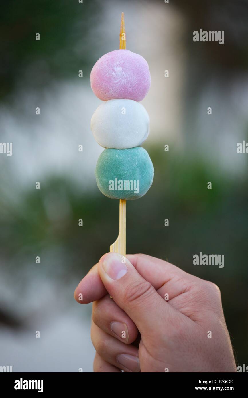 Young man's hand holding mochi dessert, Japantown, San Francisco