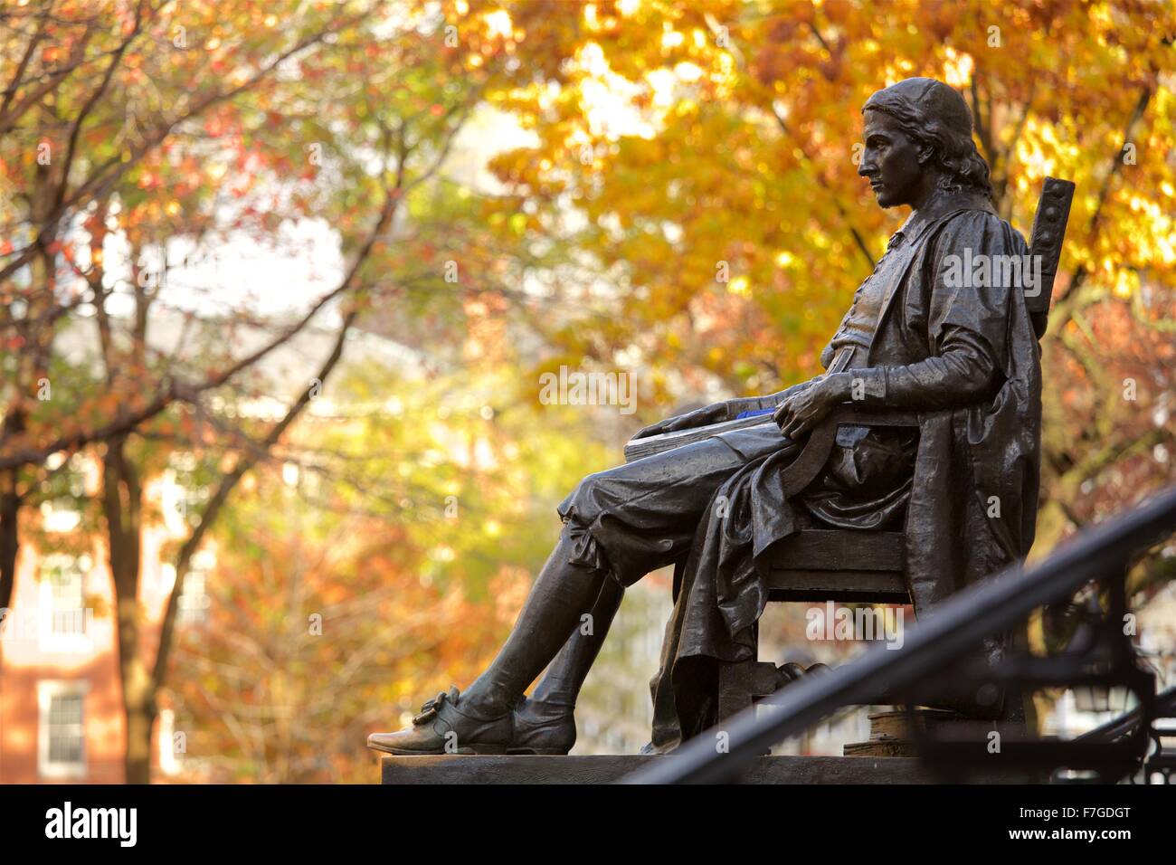 John Harvard statue in Harvard Yard in autumn, fall in Cambridge, Massachusetts. Stock Photo