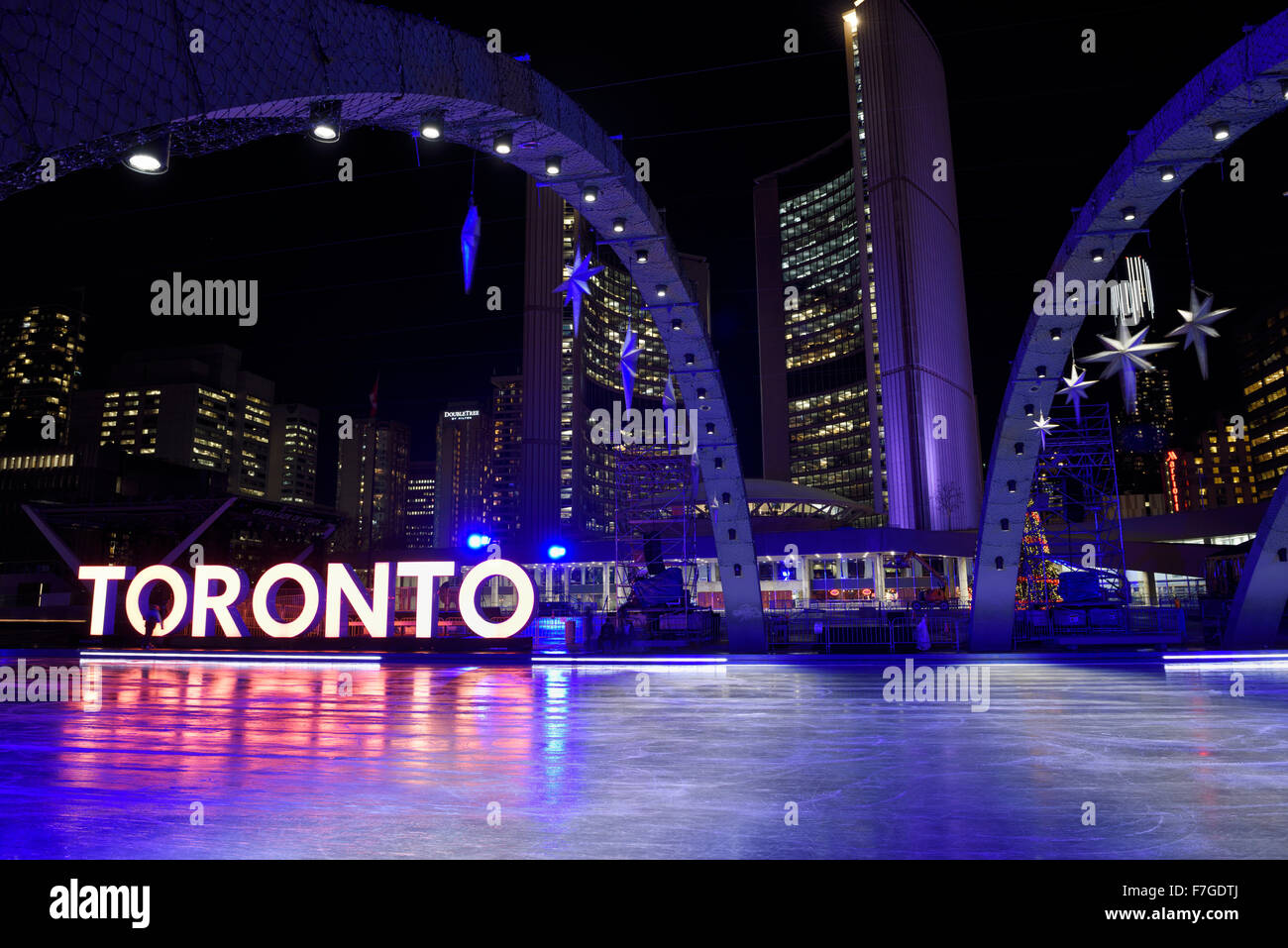 Purple arches at ice rink of Nathan Phillips Square at night with City Hall and Toronto sign in winter Stock Photo