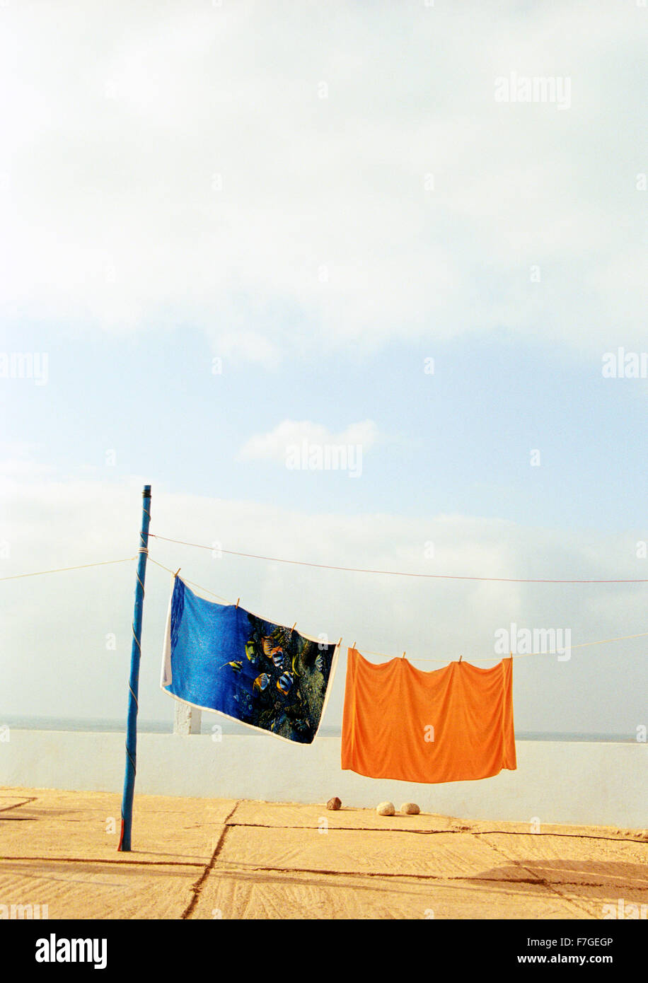 Colorful beach towels hand to dry at a camping ground in Sidi Ifni. Morocco Stock Photo