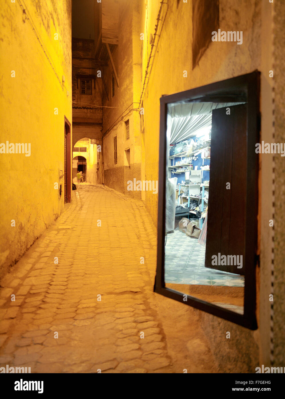 A mirror reflects a merchants store. In an alleyway in the Fes al Bali medina. Fes, Morocco, North Africa. Stock Photo