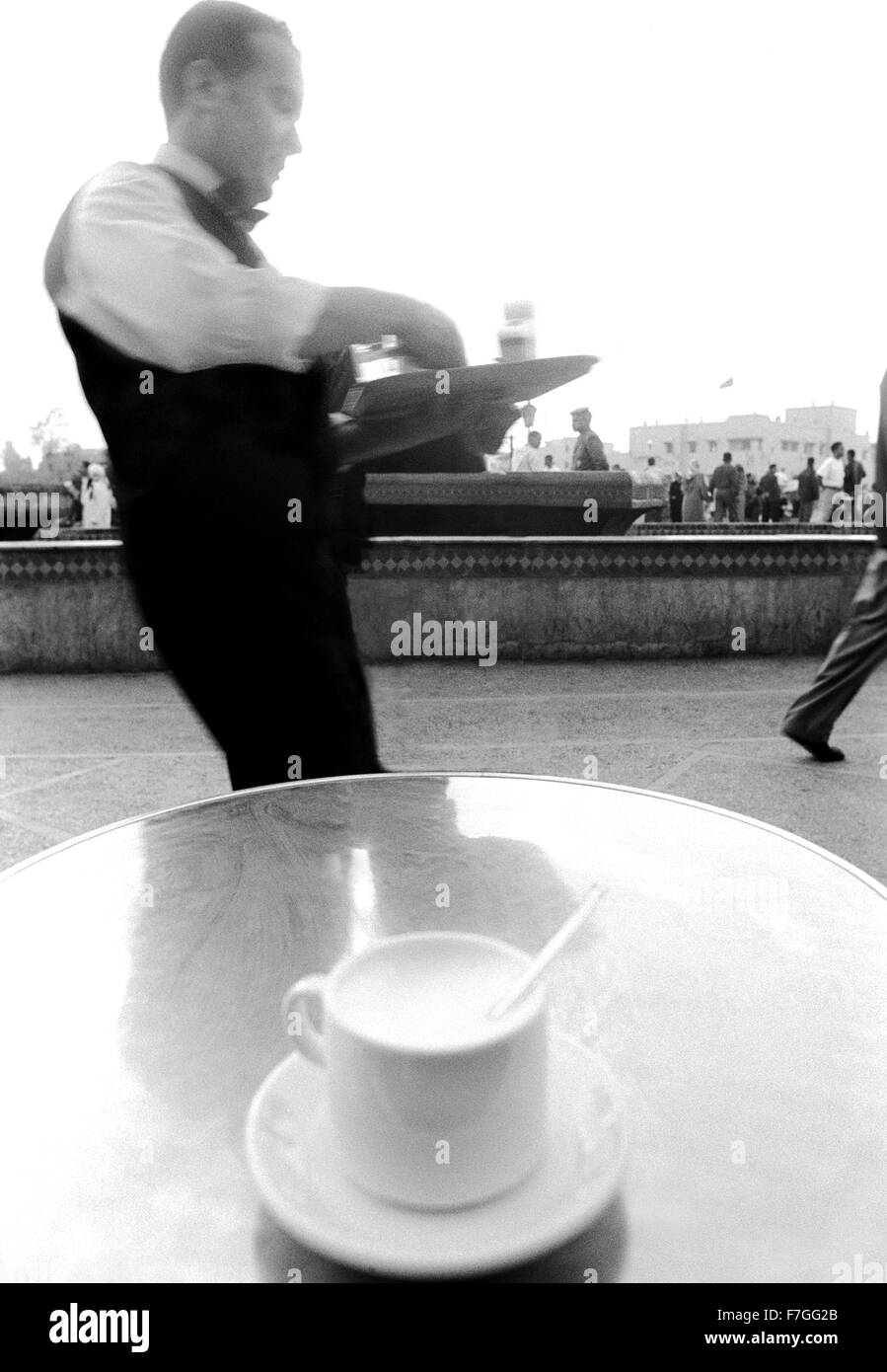 A waiter serves a  hot cappuccino at a cafe in Marrakech, Morocco Stock Photo
