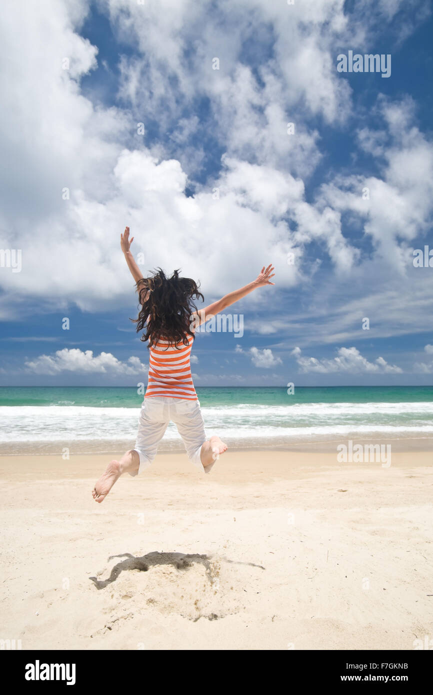Jumping on beach Stock Photo