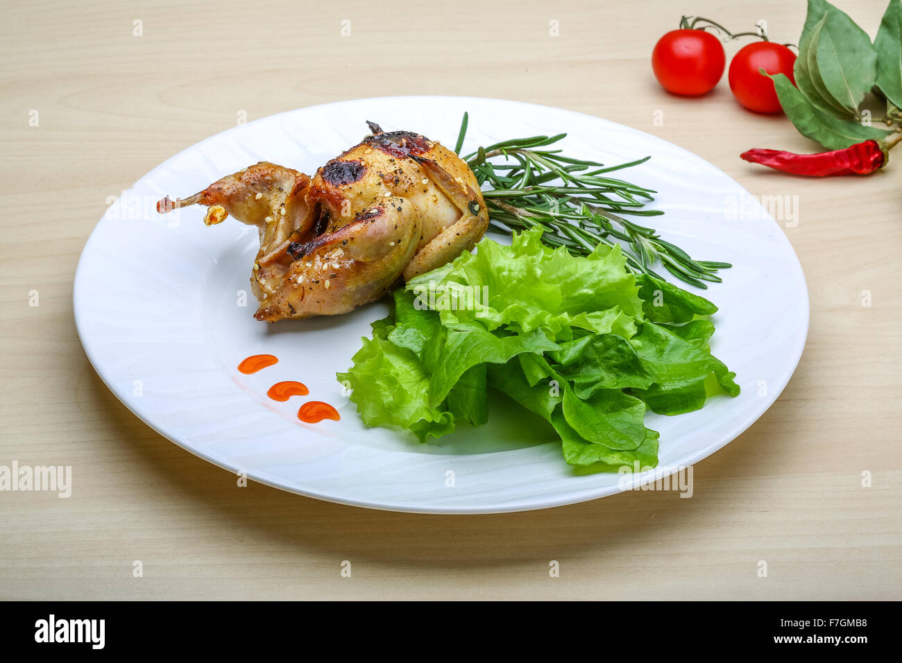 Roasted Quail with rosemary and spices on the wood background Stock Photo Alamy