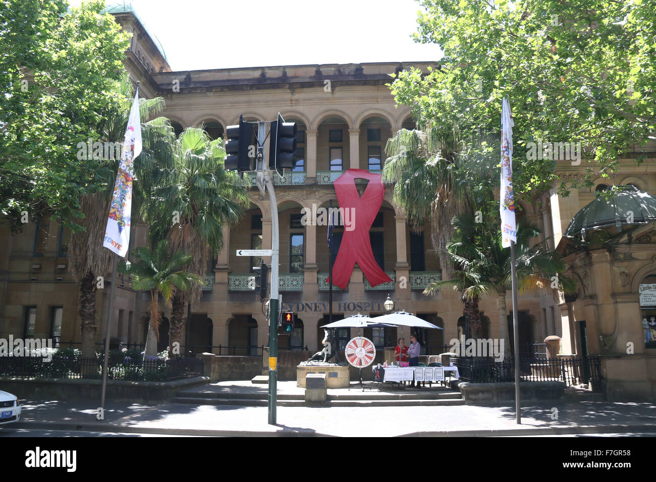 Sydney, Australia. 1 December 2015. The Sydney Hospital on Macquarie Street has a giant red ribbon for World AIDS Day. World AIDS Day raises awareness around the world about the issues surrounding HIV and AIDS. It is a day for people to show their support for people living with HIV and to commemorate people who have died. Copyright Credit:  2015 Richard Milnes/Alamy Live News. Stock Photo