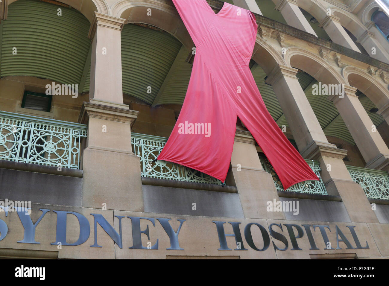 Sydney, Australia. 1 December 2015. The Sydney Hospital on Macquarie Street has a giant red ribbon for World AIDS Day. World AIDS Day raises awareness around the world about the issues surrounding HIV and AIDS. It is a day for people to show their support for people living with HIV and to commemorate people who have died. Copyright Credit:  2015 Richard Milnes/Alamy Live News. Stock Photo