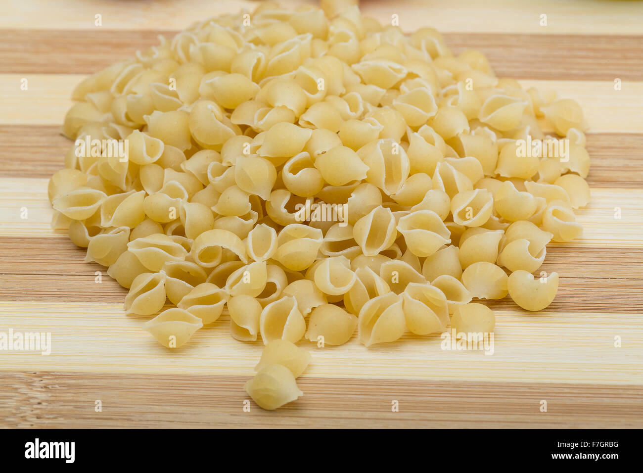 Raw Shell pasta on the wood background Stock Photo - Alamy