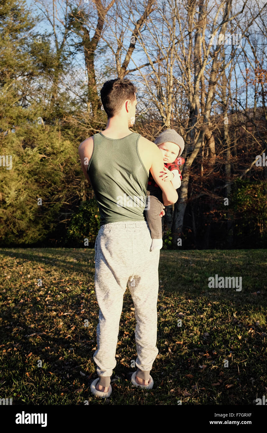 Man from behind holding baby boy Stock Photo