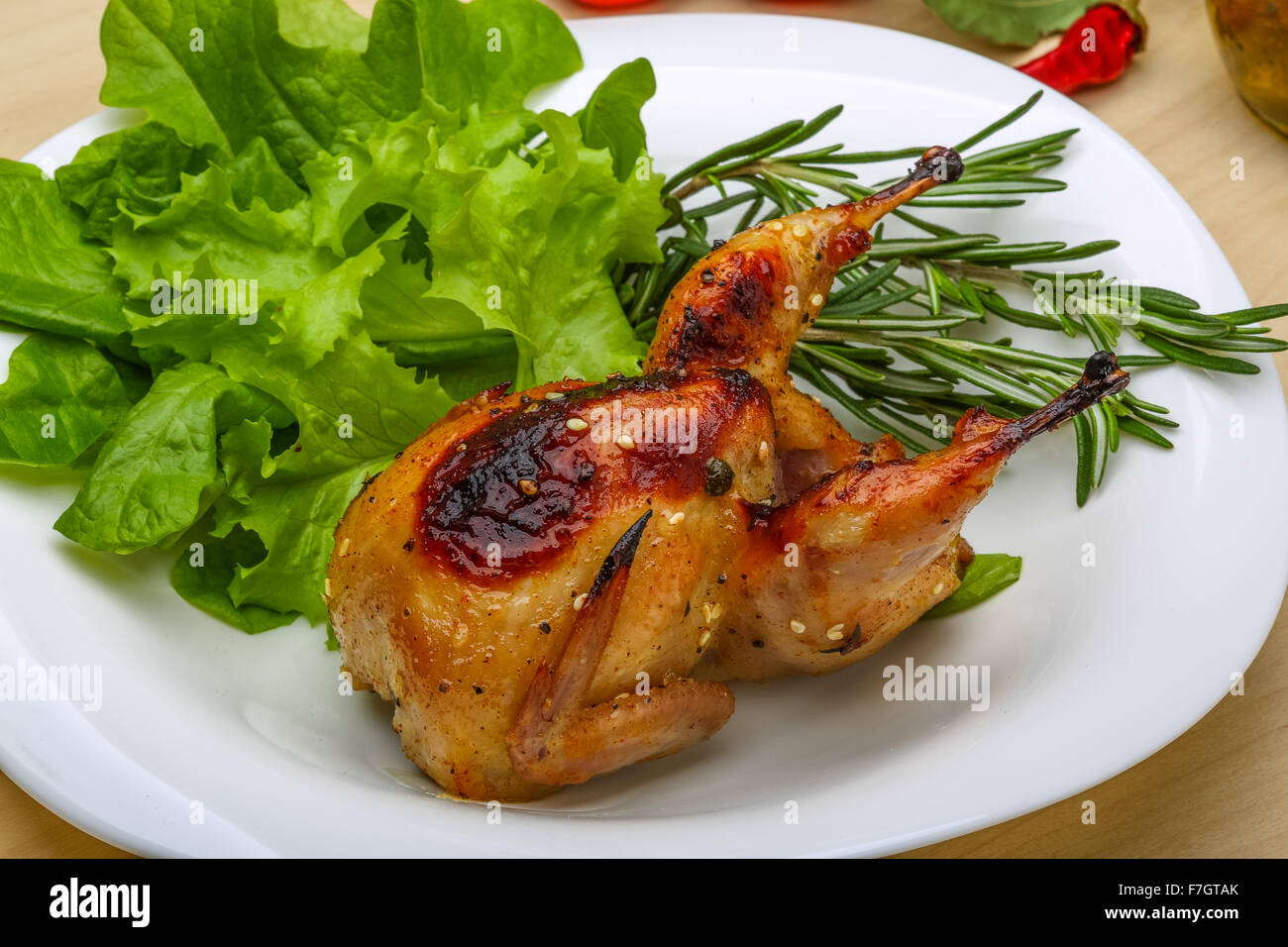 Roasted Quail with rosemary and spices on the wood background Stock Photo Alamy