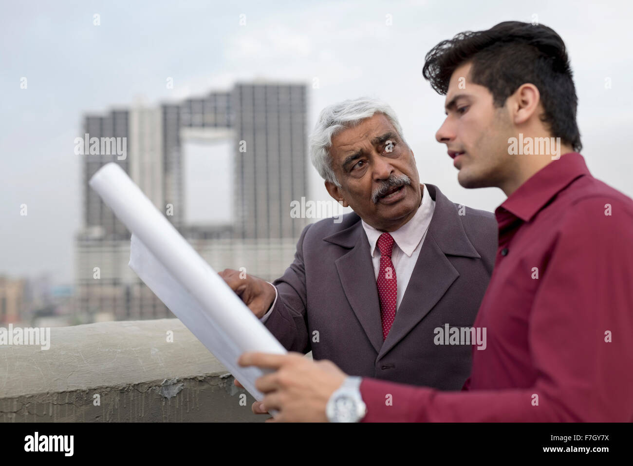 India, Architects and client discussing building plans Stock Photo - Alamy