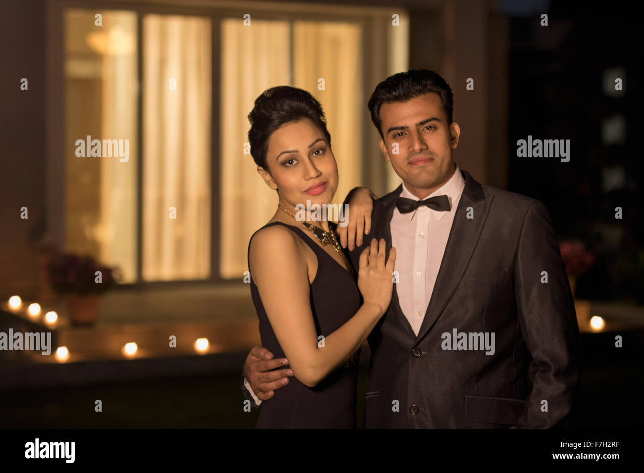 Man and woman in evening wear standing outside Stock Photo - Alamy