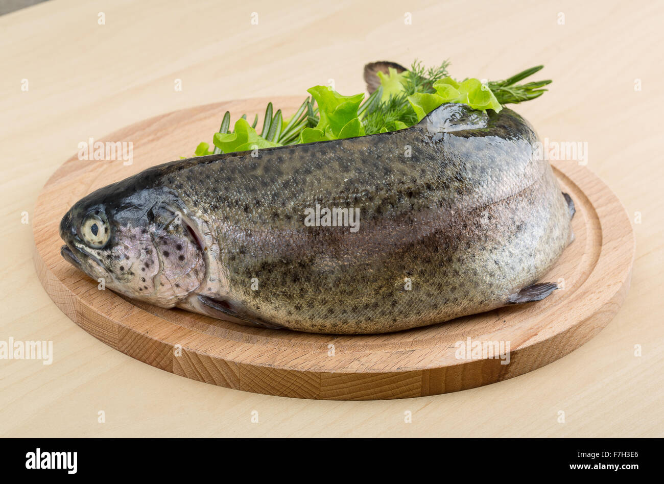 Raw fresh trout on the wood background with herbs Stock Photo - Alamy