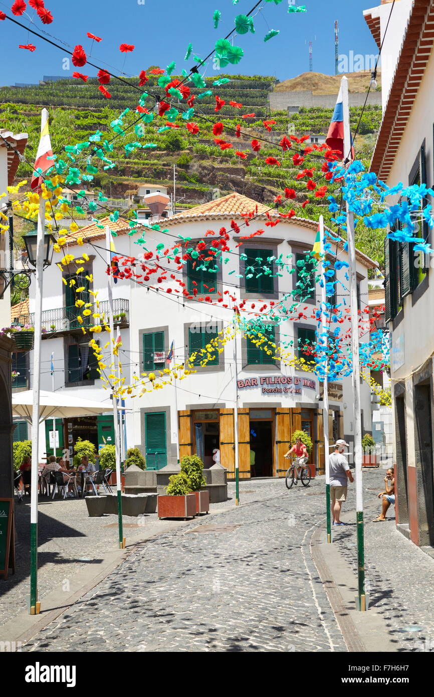 Street decorated with paper flowers on feast of Madeira, Camara de Lobos, Madeira Island, Portugal Stock Photo