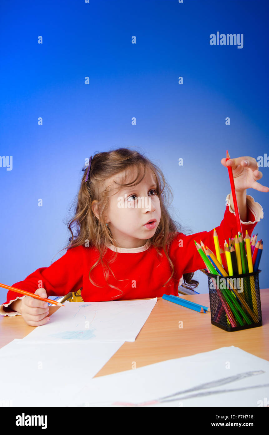 Little girl drawing with pencils Stock Photo - Alamy