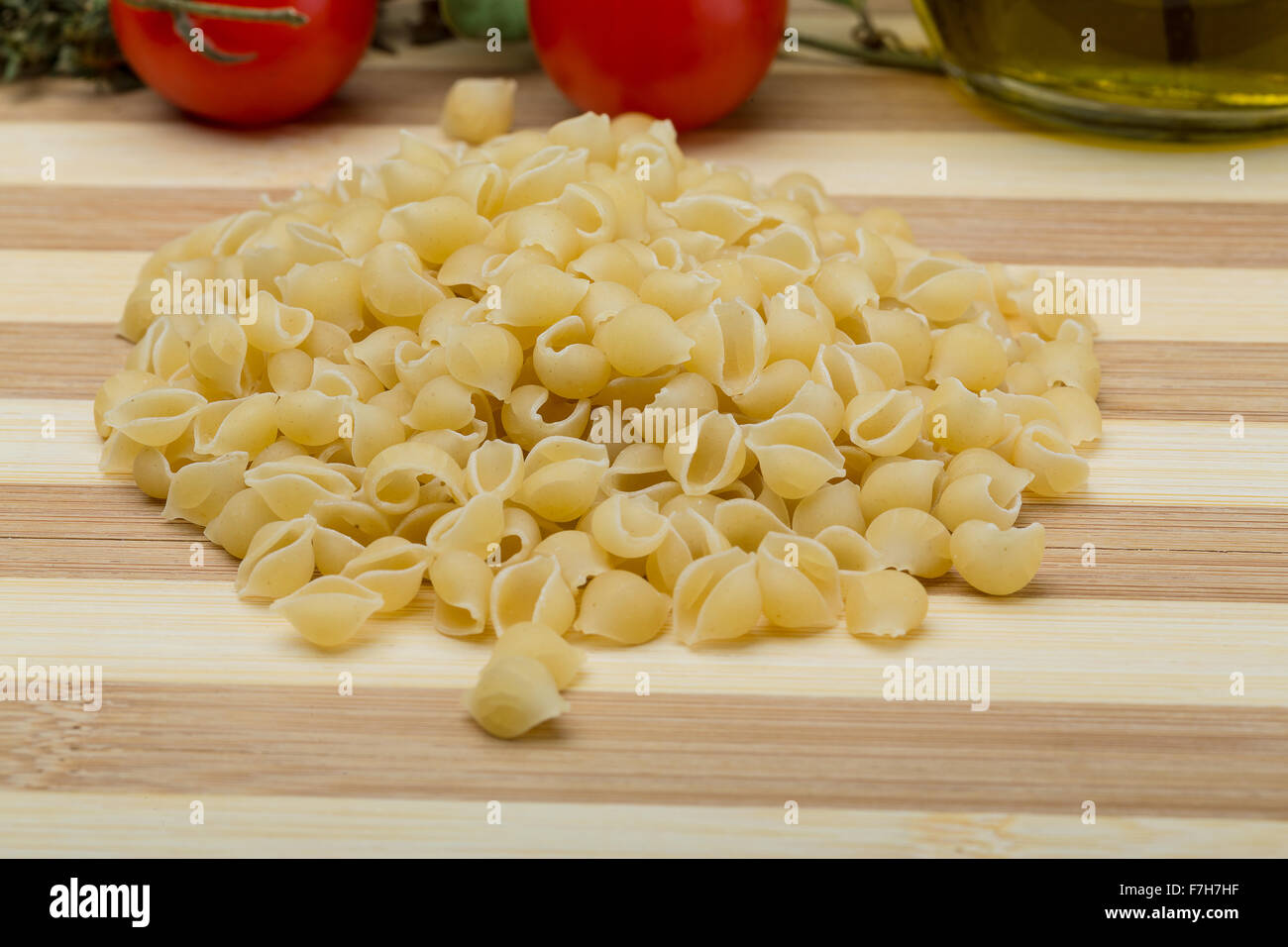 Raw Shell pasta on the wood background Stock Photo - Alamy