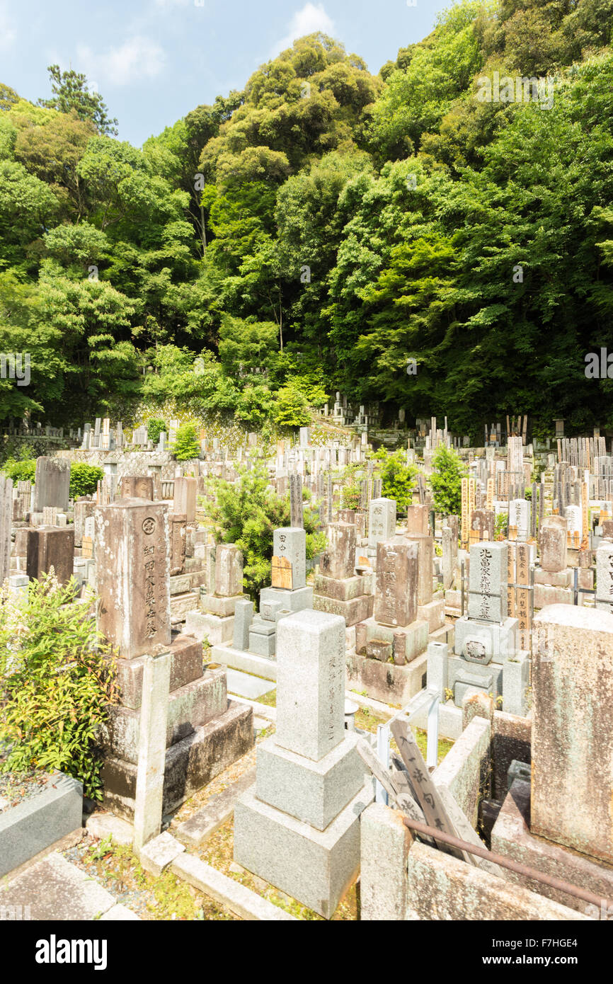 Ancient engraved headstones of the deceased at a Buddhist cemetery upstairs and behind Chion-In temple in historic Kyoto, Japan. Stock Photo
