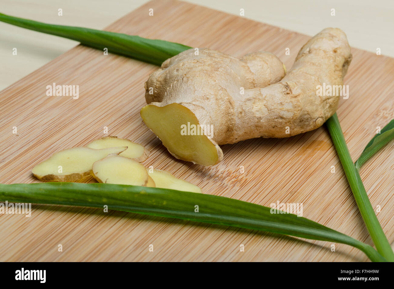 Ginger root on the wood background with leaves Stock Photo Alamy