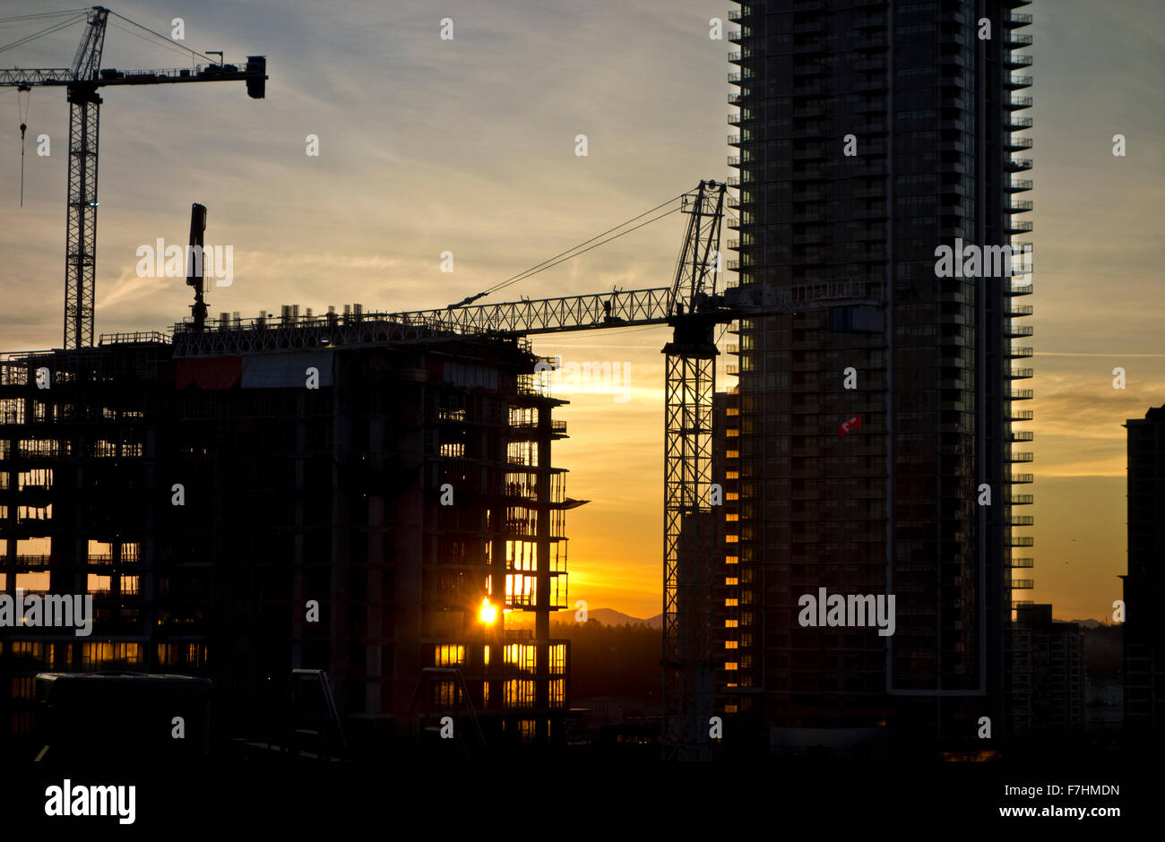 Silhouettes of the construction cranes and condo towers under construction in the Brentwood mall area of Burnaby, BC, Canada. Amazing Brentwood condos. Stock Photo
