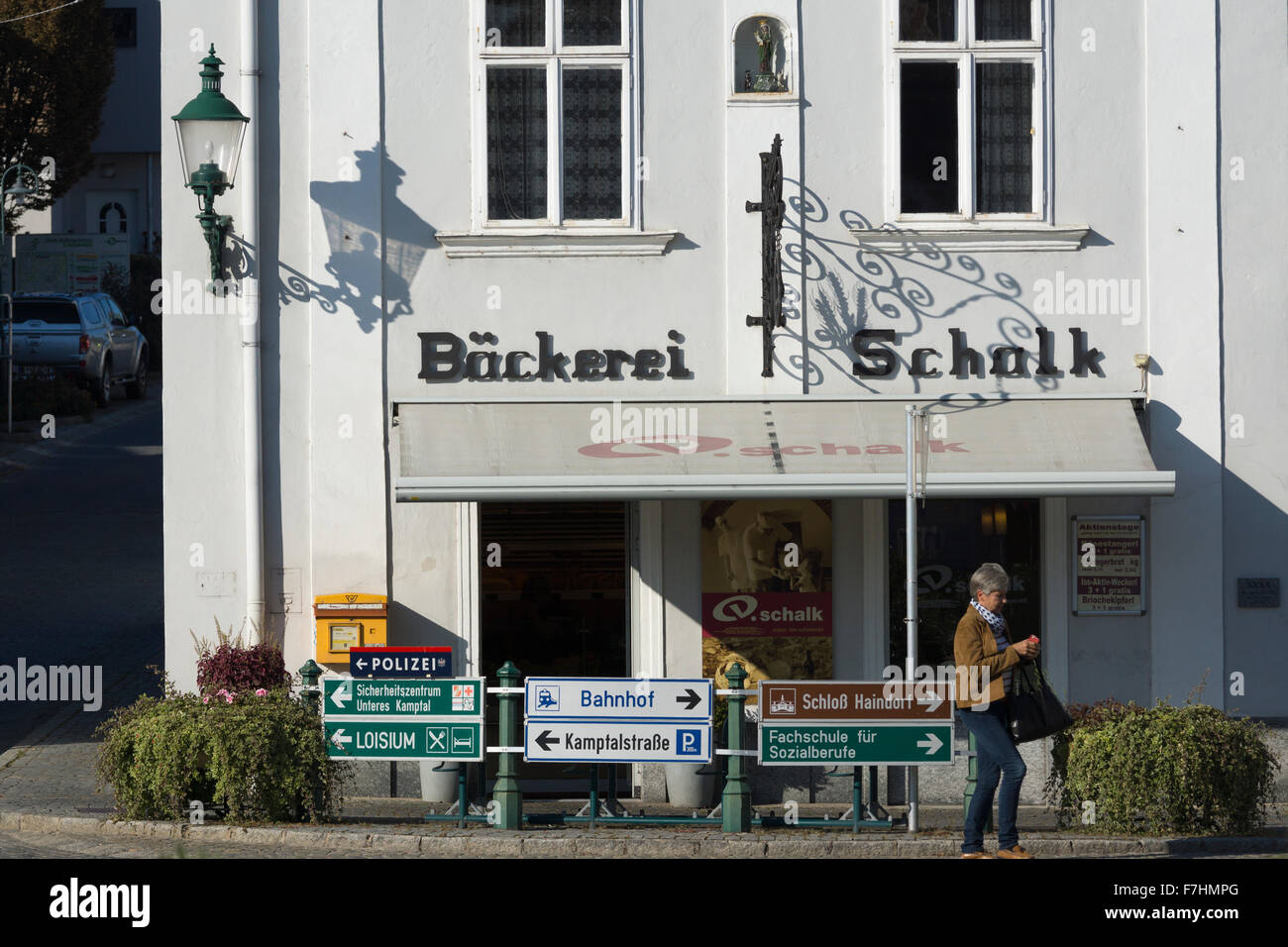 Schalk bakery (Bäckerei Schalk) and direction signs in German in the town of Langenlois, Lower Austria. A typical artisan bakery in Austria Stock Photo