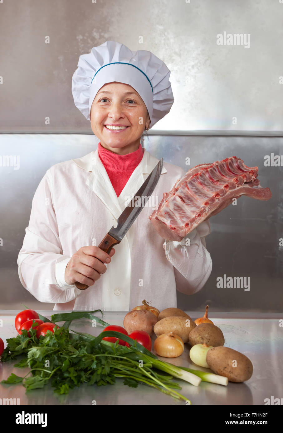 F. Cook Cook woman with raw meat in kitchen Stock Photo - Alamy