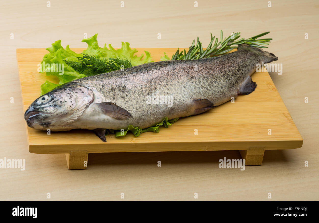 Raw fresh trout on the wood background with herbs Stock Photo - Alamy