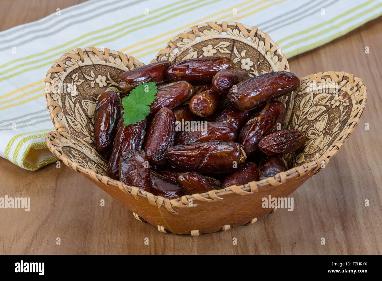 Dry Dates fruit in the bowl on the wood background Stock Photo - Alamy