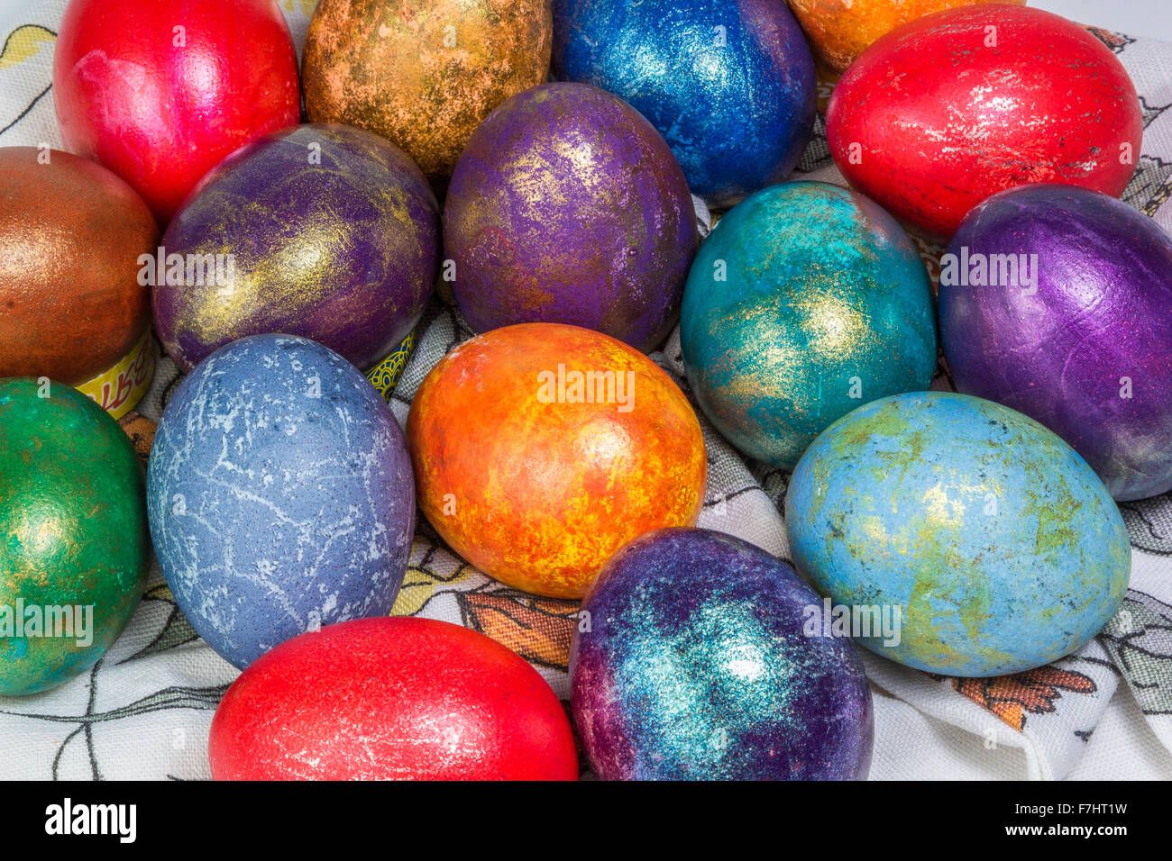 heap of painted easter eggs with metallic glitter on a towel Stock