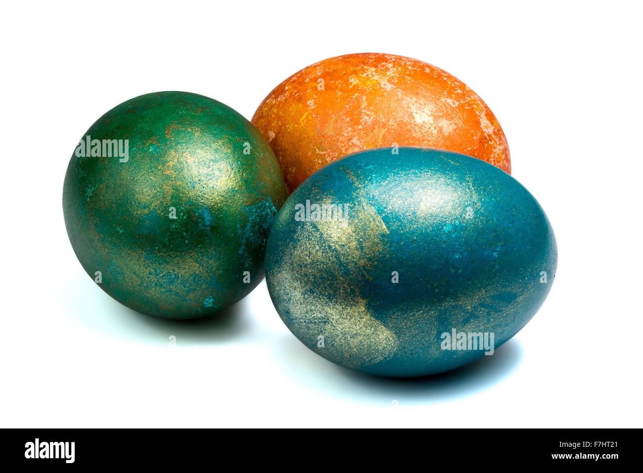 three painted easter eggs with metallic glitter isolated Stock Photo