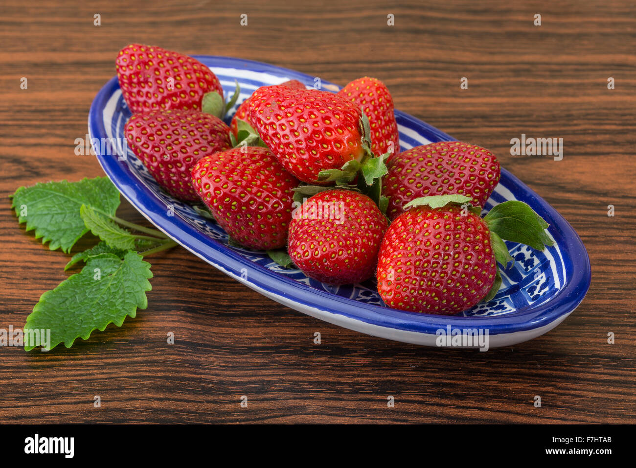 Fresh ripe strawberries in the bowl on wooden background Stock Photo ...