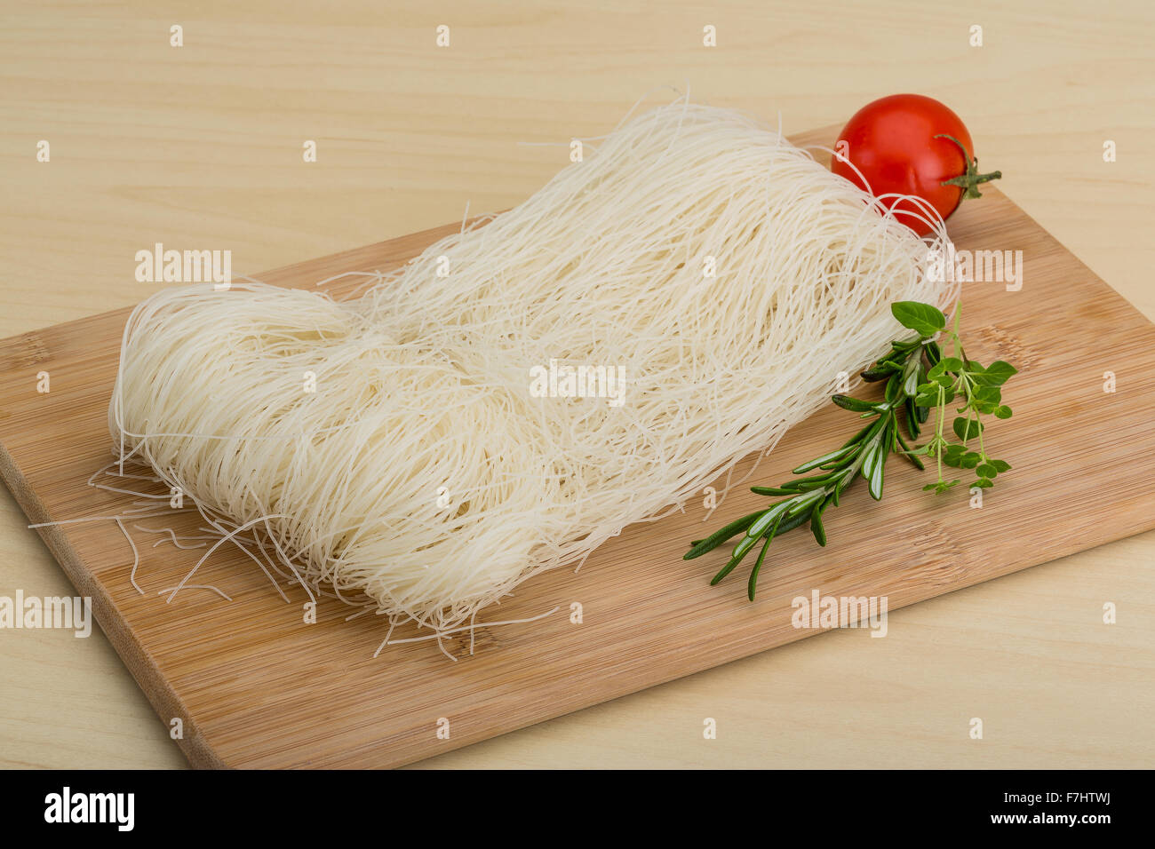 Raw rice noodles with rosemary and tomato Stock Photo Alamy