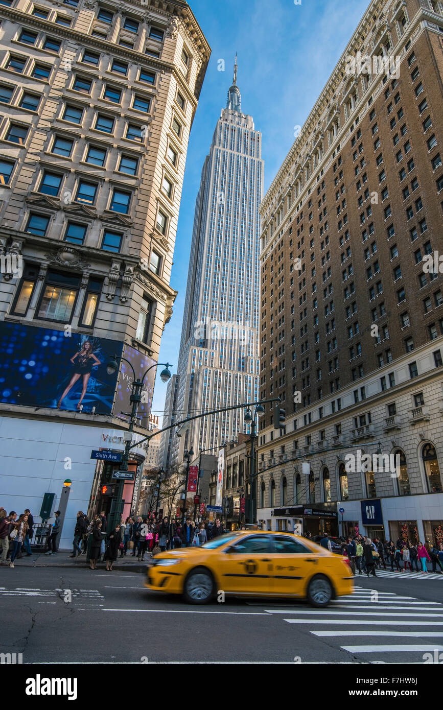 Empire State Building and blurred yellow cab, Manhattan, New York, USA Stock Photo