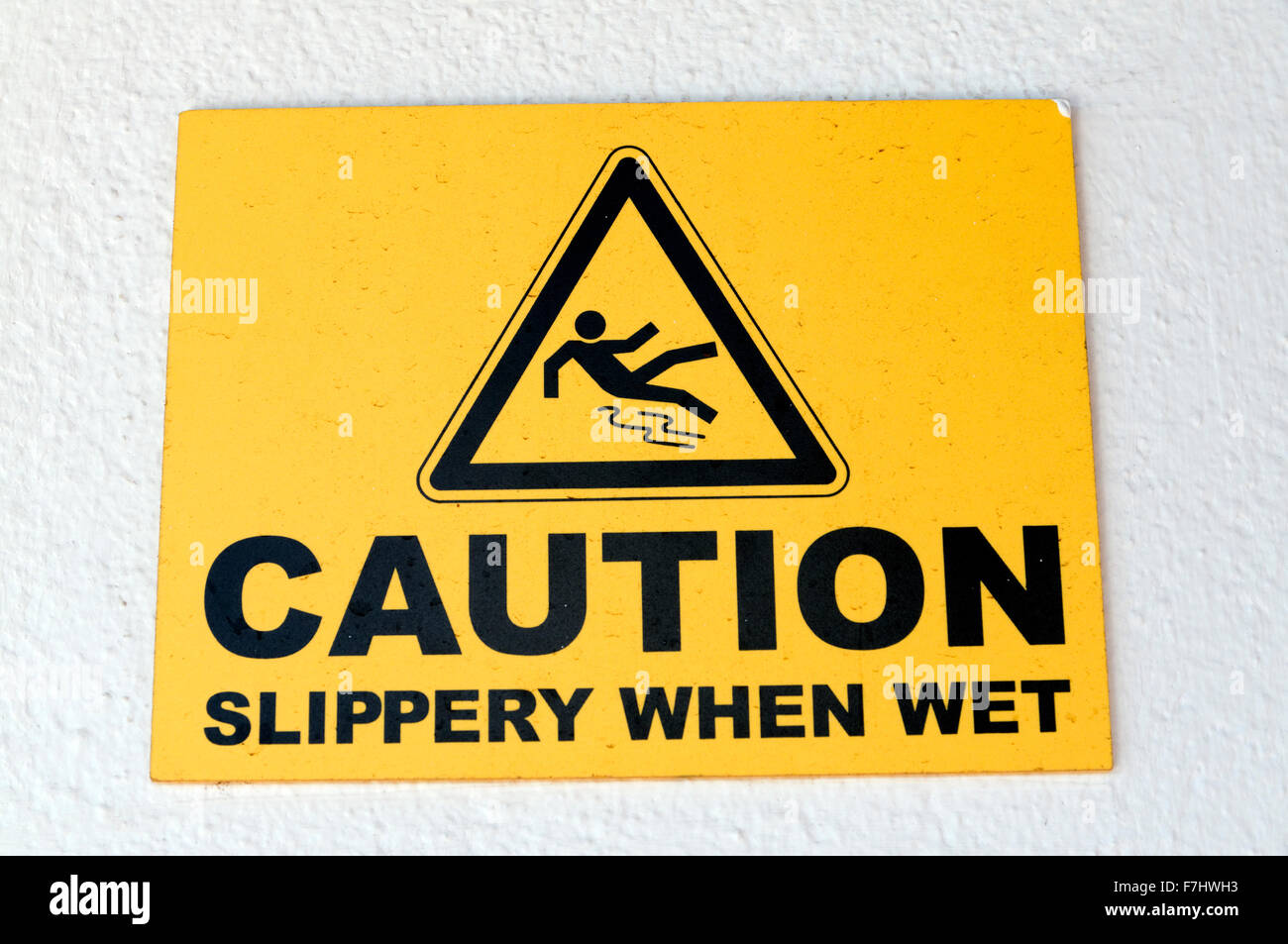 Warning sign for slippery surface, Playa Blanca, Lanzarote, Canary Islands, Spain. Stock Photo