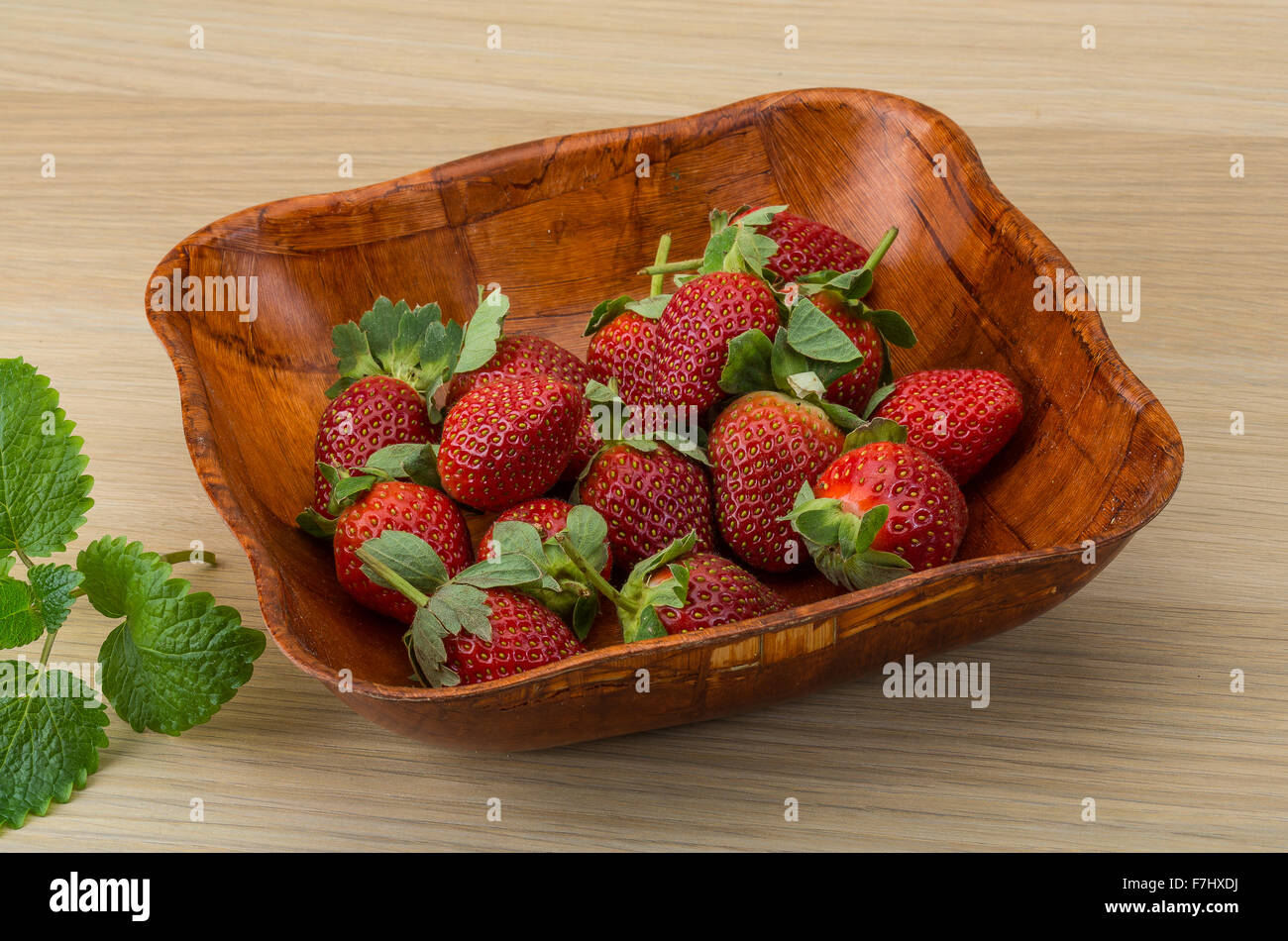 Fresh ripe strawberries in the bowl on wooden background Stock Photo ...