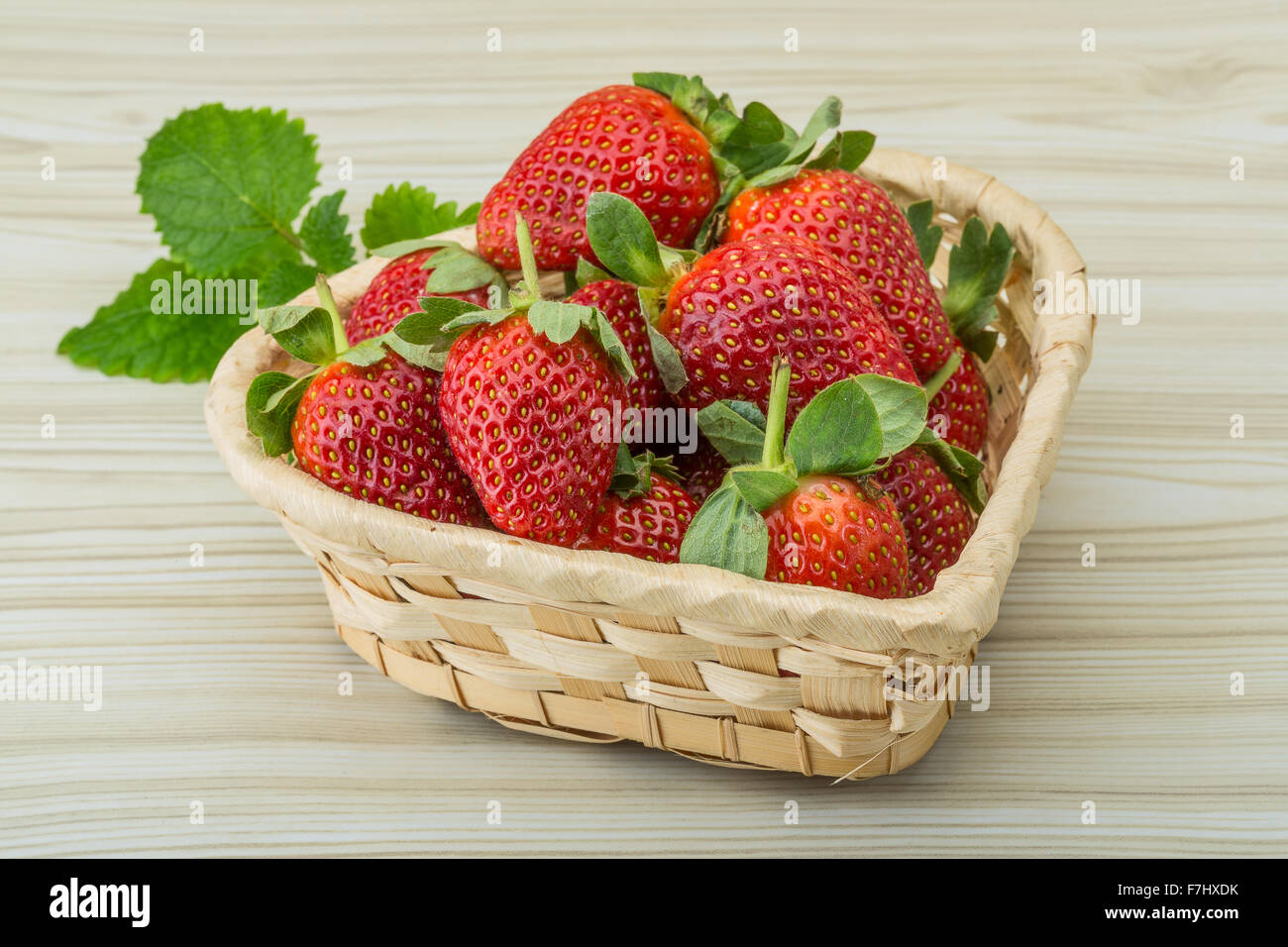 Fresh ripe strawberries in the bowl on wooden background Stock Photo ...